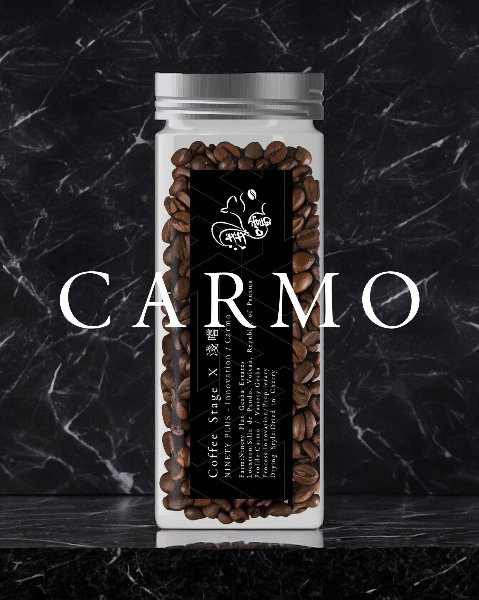 Glass jar filled with Carmo coffee beans from Ninety Plus, featuring a black label with white text and a butterfly logo, set against a dark marble background with white Carmo text overlay.