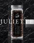 Glass jar of Ninety Plus Coffee Juliette beans with black label, displayed on dark marble background. Text "JULIETTE" in white overlays bottom of image.