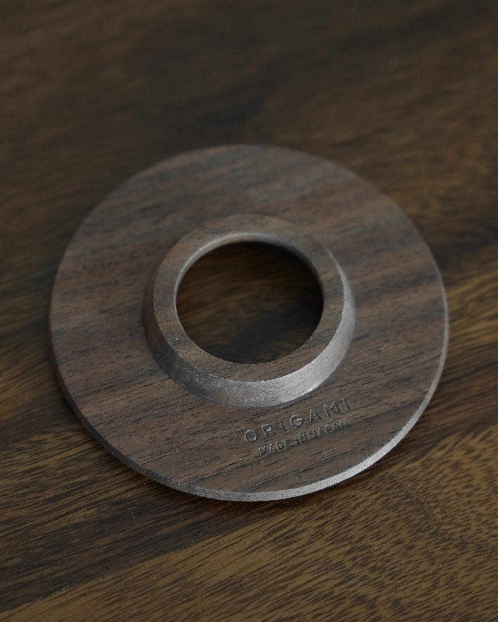 Ninety Plus Coffee Kone Ring 10.1 in walnut wood, circular stand for mini pour-over coffee filter, 2024 version, smooth surface with engraved logo, placed on dark wooden background