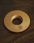 Ninety Plus Coffee Kone Ring 10.1 in cherry wood color, circular wooden base for mini pour-over coffee dripper, featuring a central hole and engraved logo, displayed on dark wood surface