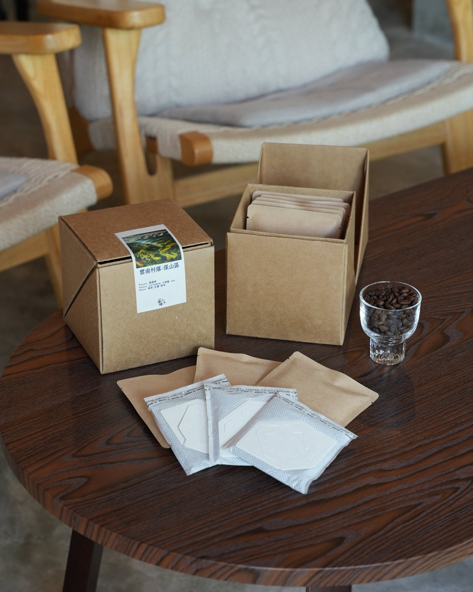 Yunnan CATIMOR 14A coffee product display with packaging, drip bags, and coffee beans on wooden table, showcasing eco-friendly packaging and brewing options for Sip Coffee&