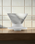 HARIO V60 NEO 01 clear pour-over coffee dripper on a Japanese-style coffee brewing counter, cover image candidate