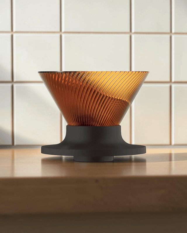 HARIO V60 NEO 01 amber pour-over coffee dripper on a Japanese-style coffee brewing counter, cover image candidate