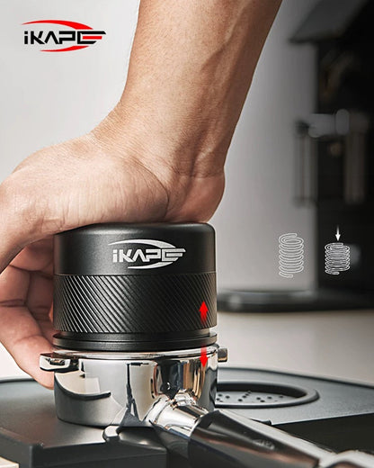 IKAPE Espresso coffee tamper with calibrated spring design being used on espresso machine portafilter, showcasing consistent pressure application for optimal coffee extraction