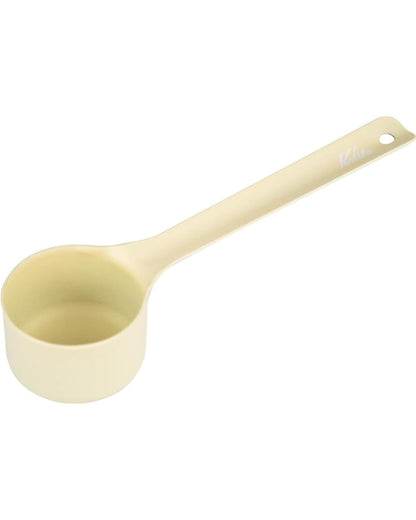 Full view of a Kalita Earth Series SUNA sand-coloured stainless steel coffee measuring scoop with a hanging hole at the end of its long handle