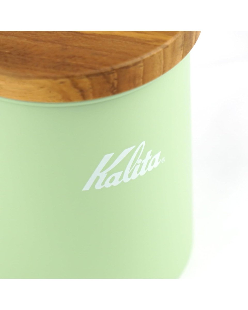 Wooden lid, canister opening and white Kalita logo details on a Kalita Earth Series MORI forest-green coffee bean canister