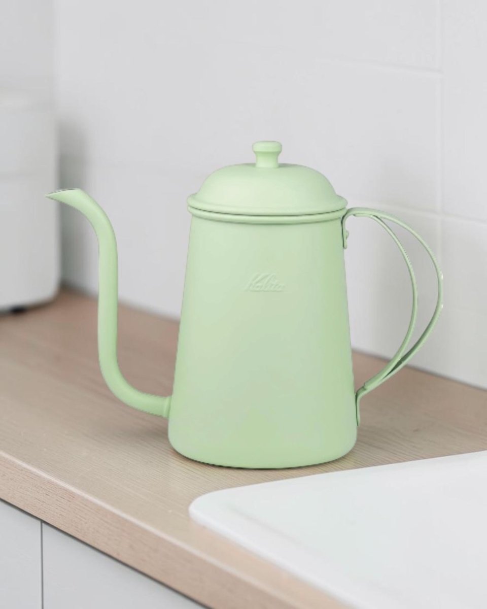 Kalita Earth Series MORI forest-green stainless steel pour-over kettle in use on a kitchen worktop