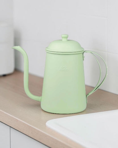 Kalita Earth Series MORI forest-green stainless steel pour-over kettle in use on a kitchen worktop