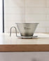 Kalita for Outdoors WDS-185K stainless steel Wave dripper on a wooden kitchen coffee countertop
