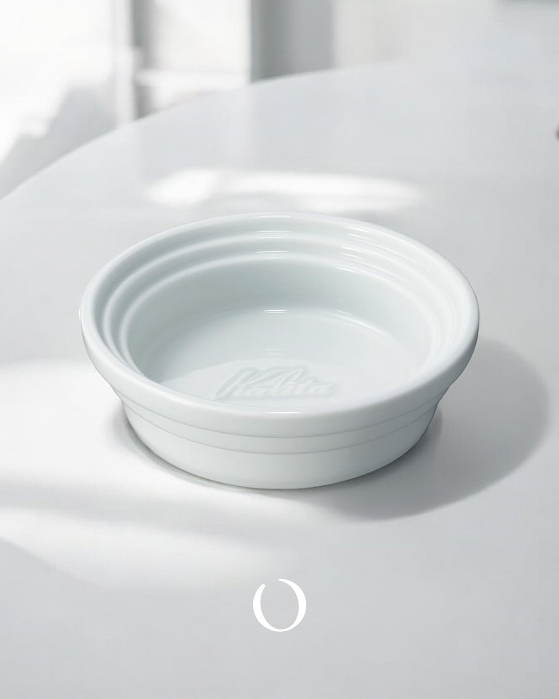 Kalita &amp; Hasami ceramic coffee dripper tray, white porcelain, circular design with raised edges, showcasing Japanese craftsmanship for pour-over coffee brewing