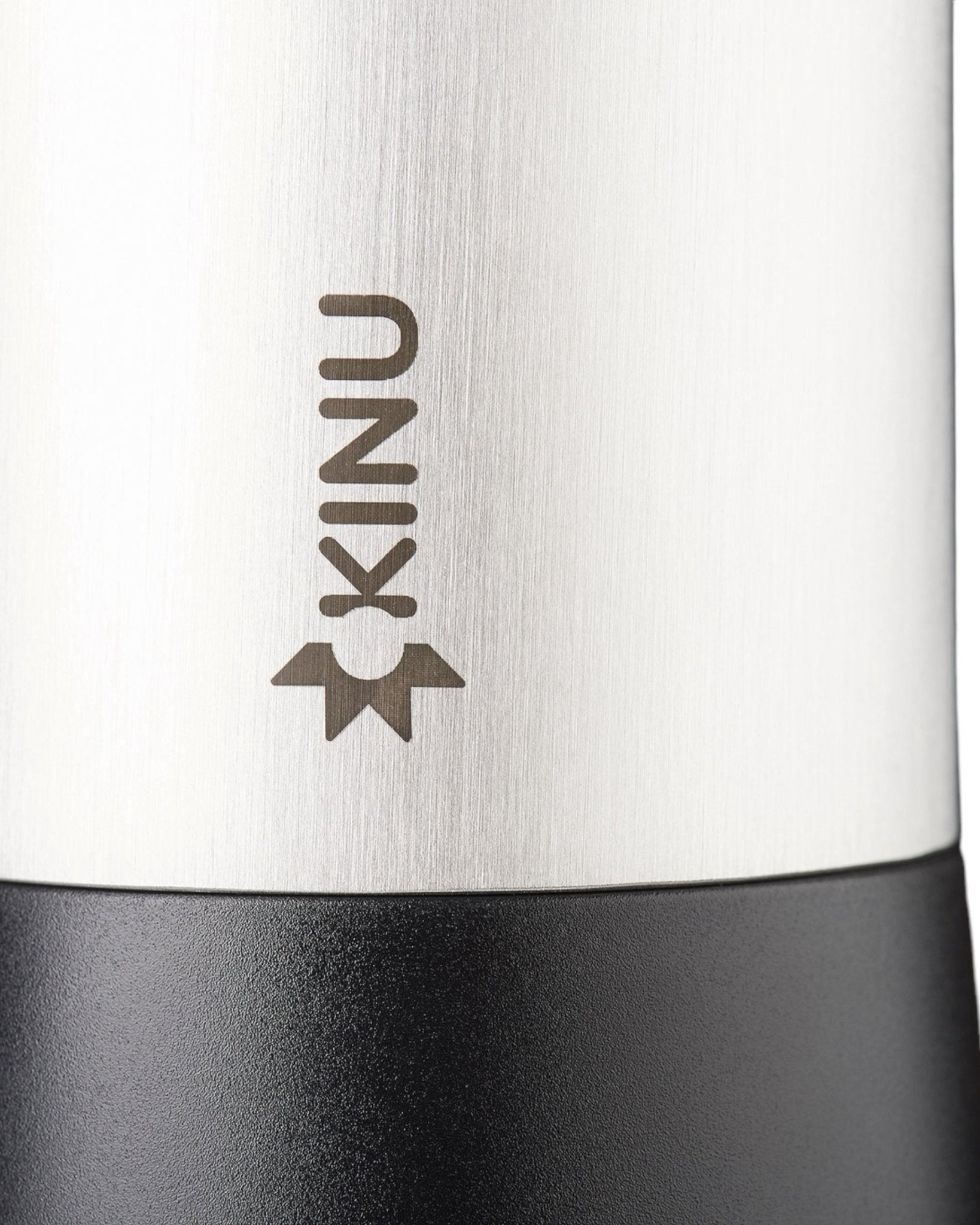 Close-up view of Kinu M47 Classic 2024 manual coffee grinder, showcasing sleek stainless steel body with engraved Kinu logo and black base, highlighting premium German craftsmanship and precision engineering for optimal coffee grinding experience