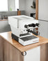 La Marzocco Linea Micra espresso machine in white on wooden kitchen counter, compact design with dual boilers and WiFi connectivity, ideal for home baristas