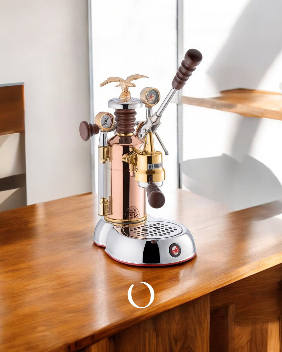 La Pavoni Esperto Edotto espresso machine with copper and brass body, wooden handles, pressure gauges, and eagle finial on wooden table, showcasing its elegant design and professional features for high-quality coffee brewing