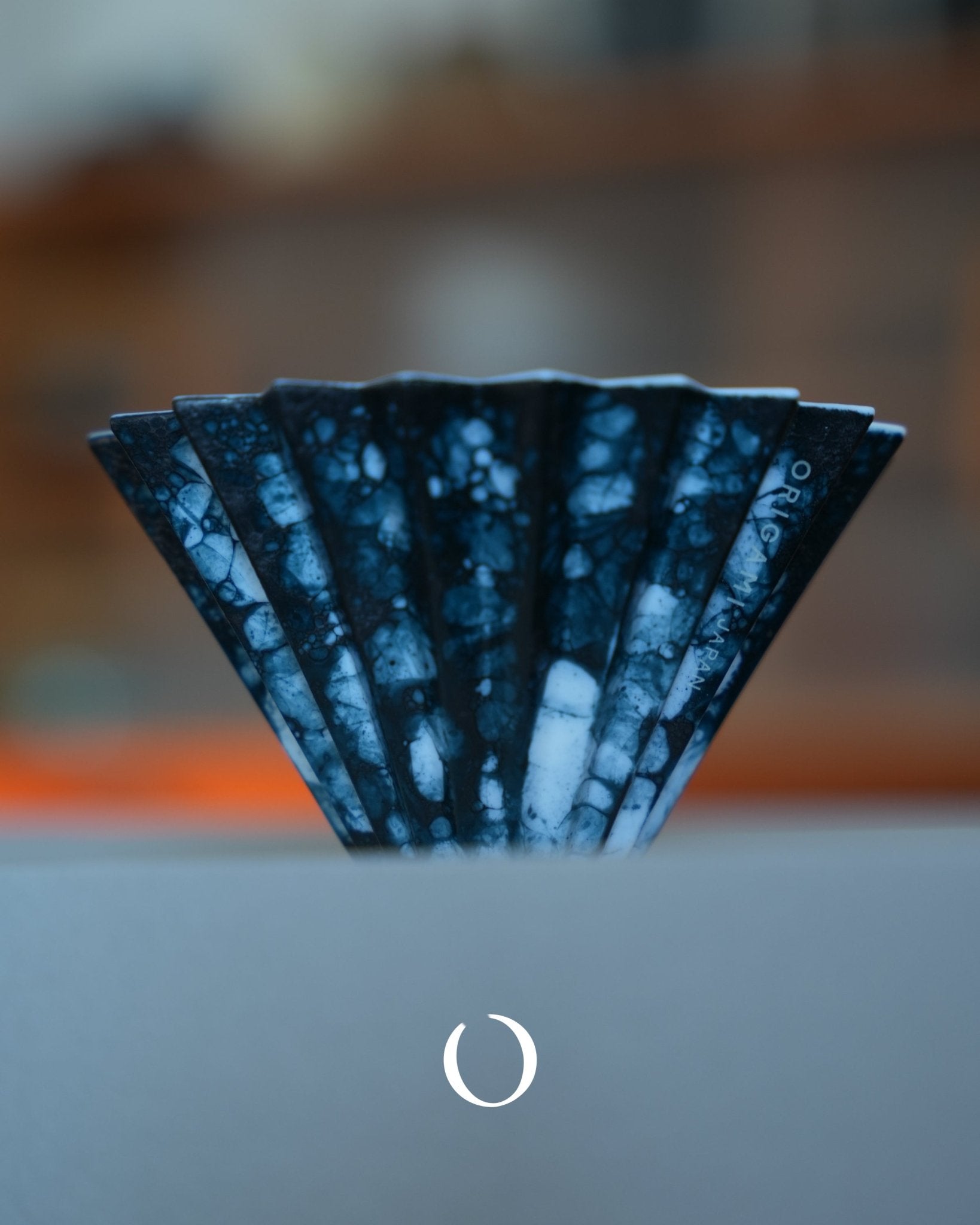 Unique blue-dyed ceramic coffee dripper with marbled pattern, part of ORIGAMI x Watanabe&