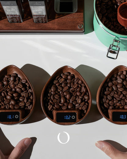 MUVNA walnut wood coffee bean digital scales with precision 0.1g accuracy, displaying coffee beans and LED screens, alongside coffee packaging and a mint green container