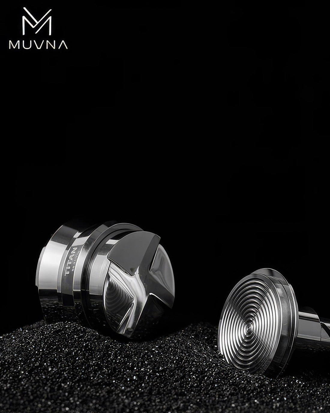 MUVNA 30-pound constant pressure spring tamper V2 in silver, showcasing two tamper bases with intricate designs on black coffee grounds, highlighting precision and quality for espresso preparation