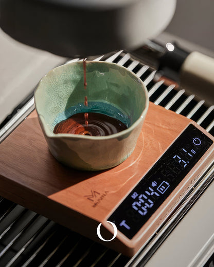 MUVNA walnut wood smart coffee scale with tilted display, showing espresso extraction into a ceramic cup, precise to 0.1g for perfect brewing ratio