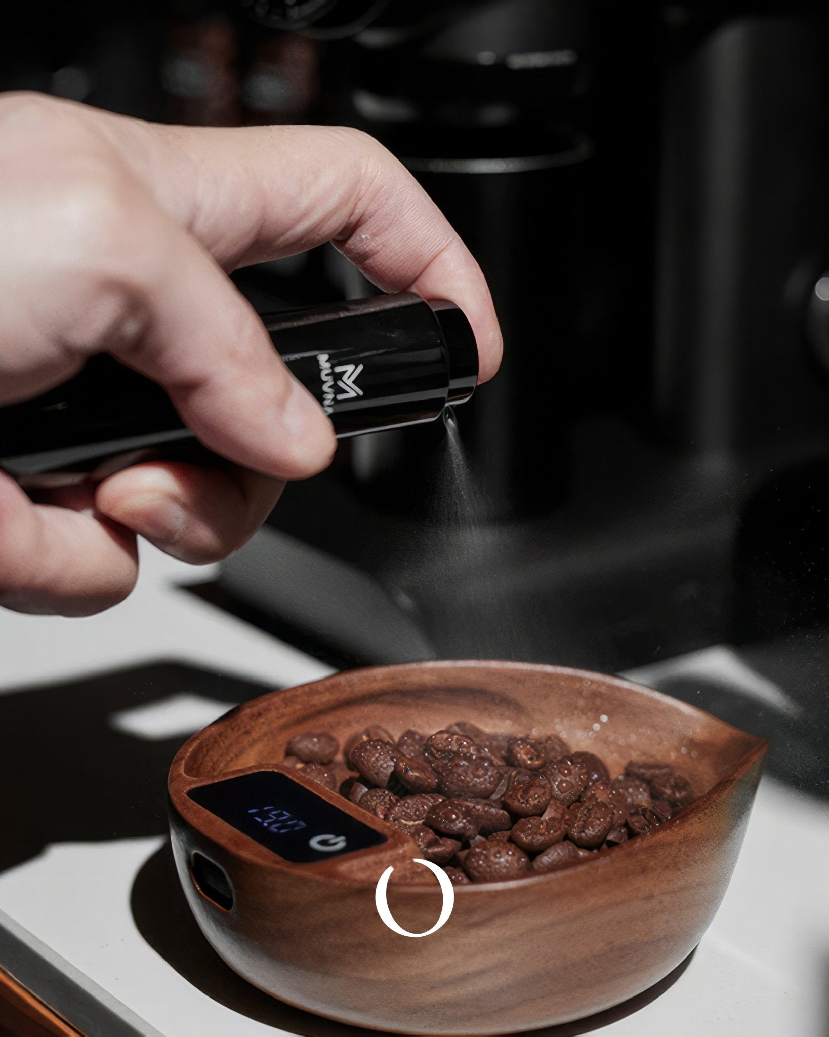 Hand pouring coffee beans into a wooden bowl on a digital scale, with a MUVNA logo visible on the grinder, showcasing precision measurement for coffee brewing