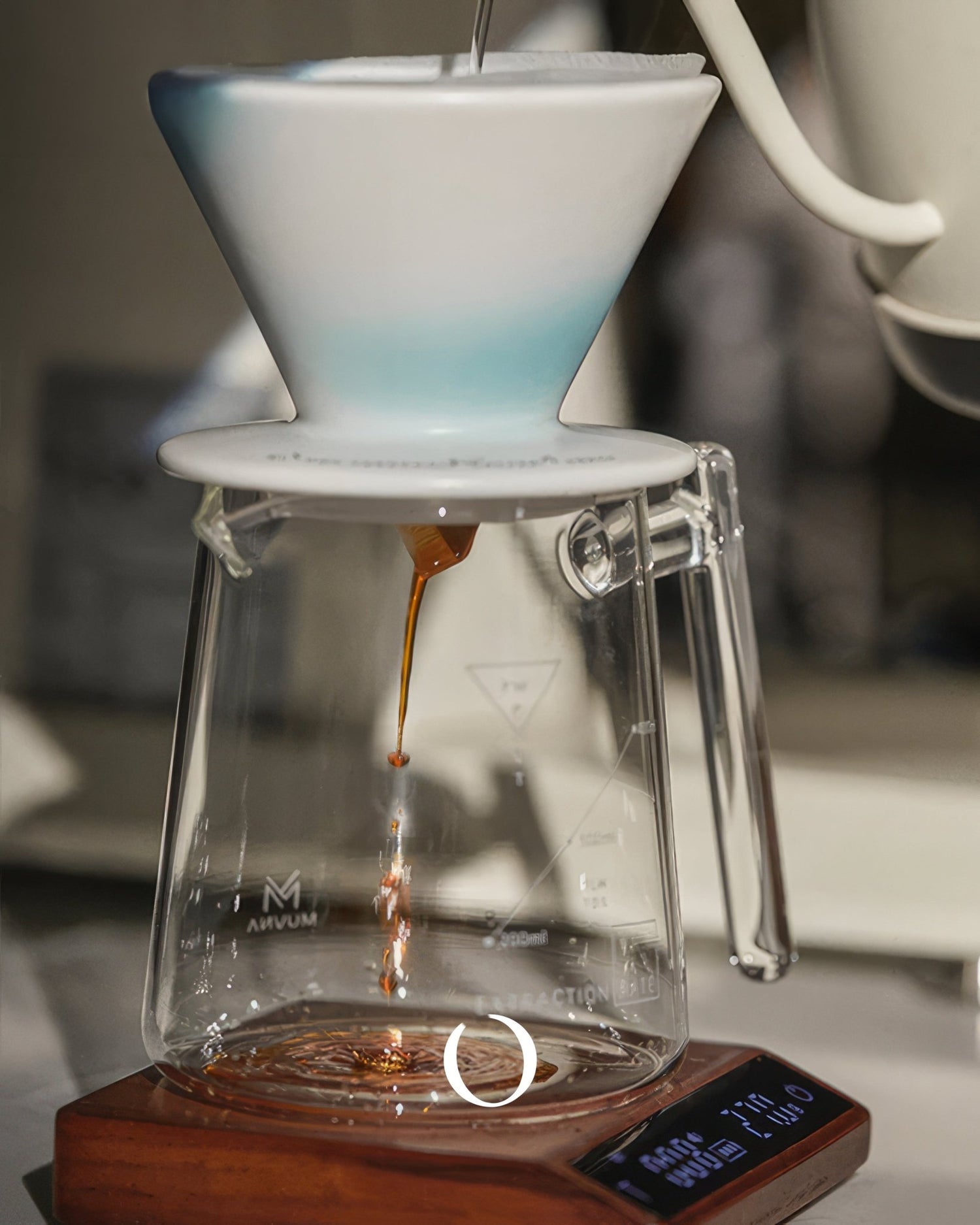 Precision coffee brewing setup with white ceramic pour-over dripper, glass carafe, and walnut digital scale displaying brewing time and weight for perfect espresso extraction