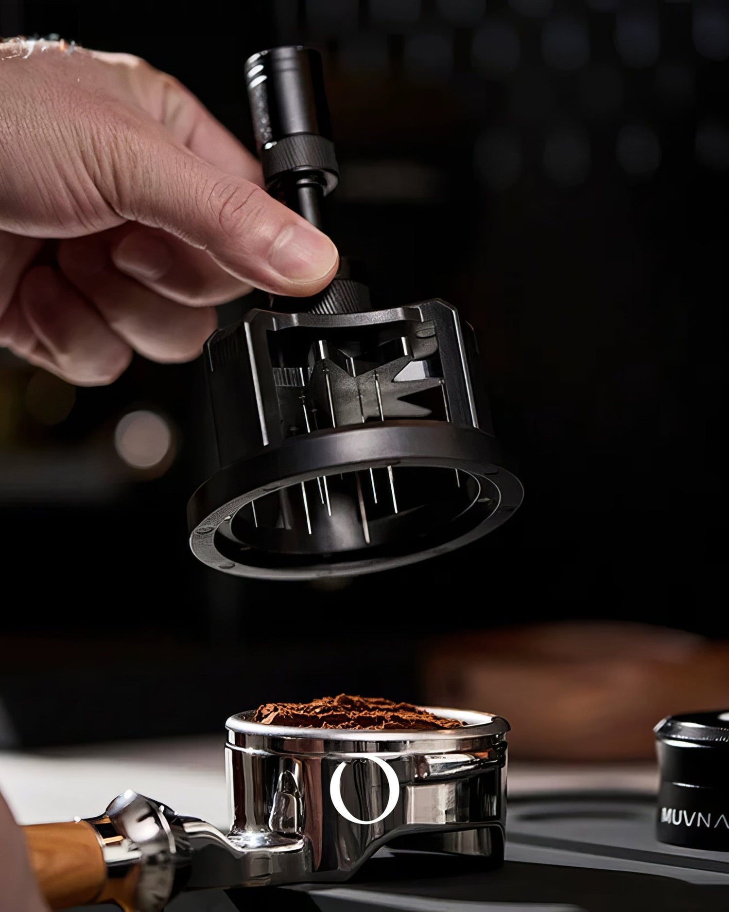 MUVNA Espresso WDT adjustable distribution tool being used to evenly distribute coffee grounds in a portafilter, showcasing precision and quality in espresso preparation