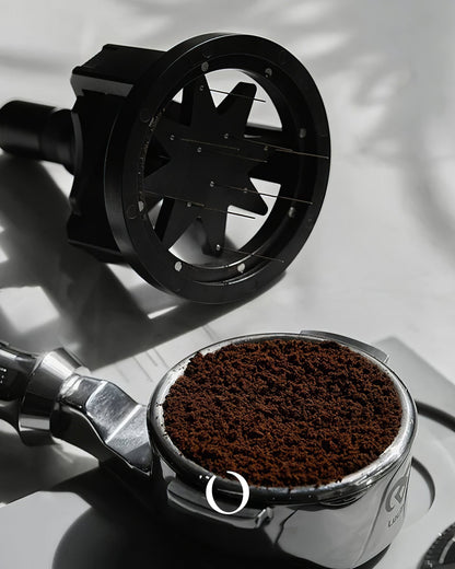 MUVNA Espresso WDT adjustable distribution tool with black circular design next to portafilter filled with ground coffee, showcasing precision coffee preparation equipment for improved espresso extraction