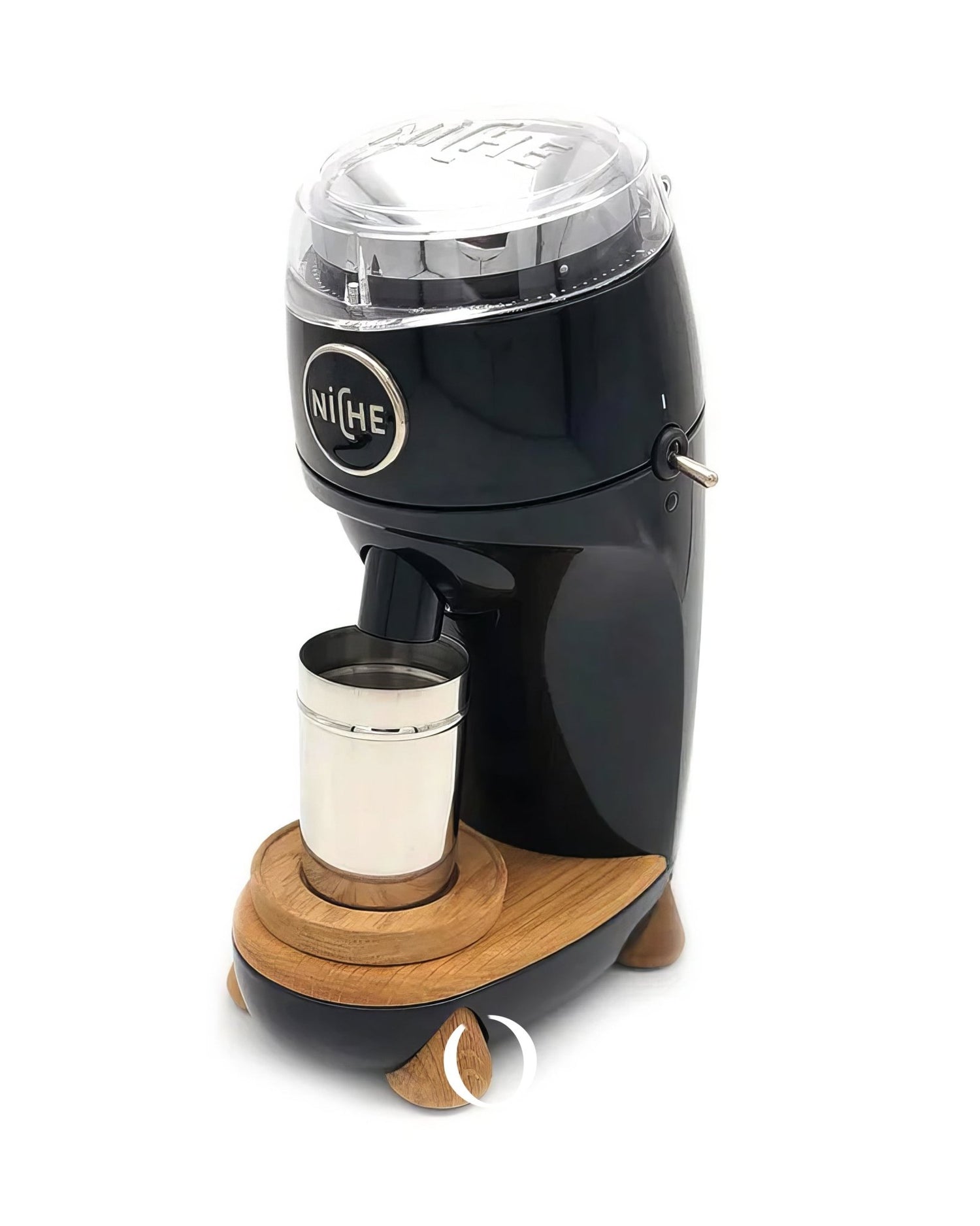 Niche Duo coffee grinder with sleek black body, clear top, and wooden base, grinding coffee into a stainless steel cup, showcasing professional-grade design for home use