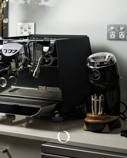 Professional espresso machine and Niche Zero coffee grinder on kitchen counter, showcasing high-end home coffee setup for brewing quality espresso