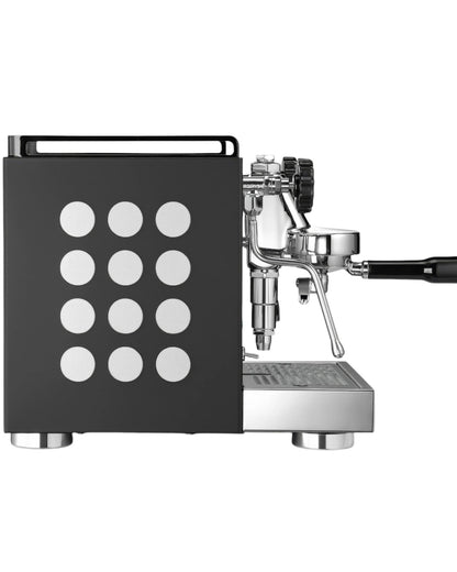 Rocket Appartamento espresso machine in black with white polka dot side panel, featuring chrome accents and professional E61 group head, showcasing compact design for home or small cafe use