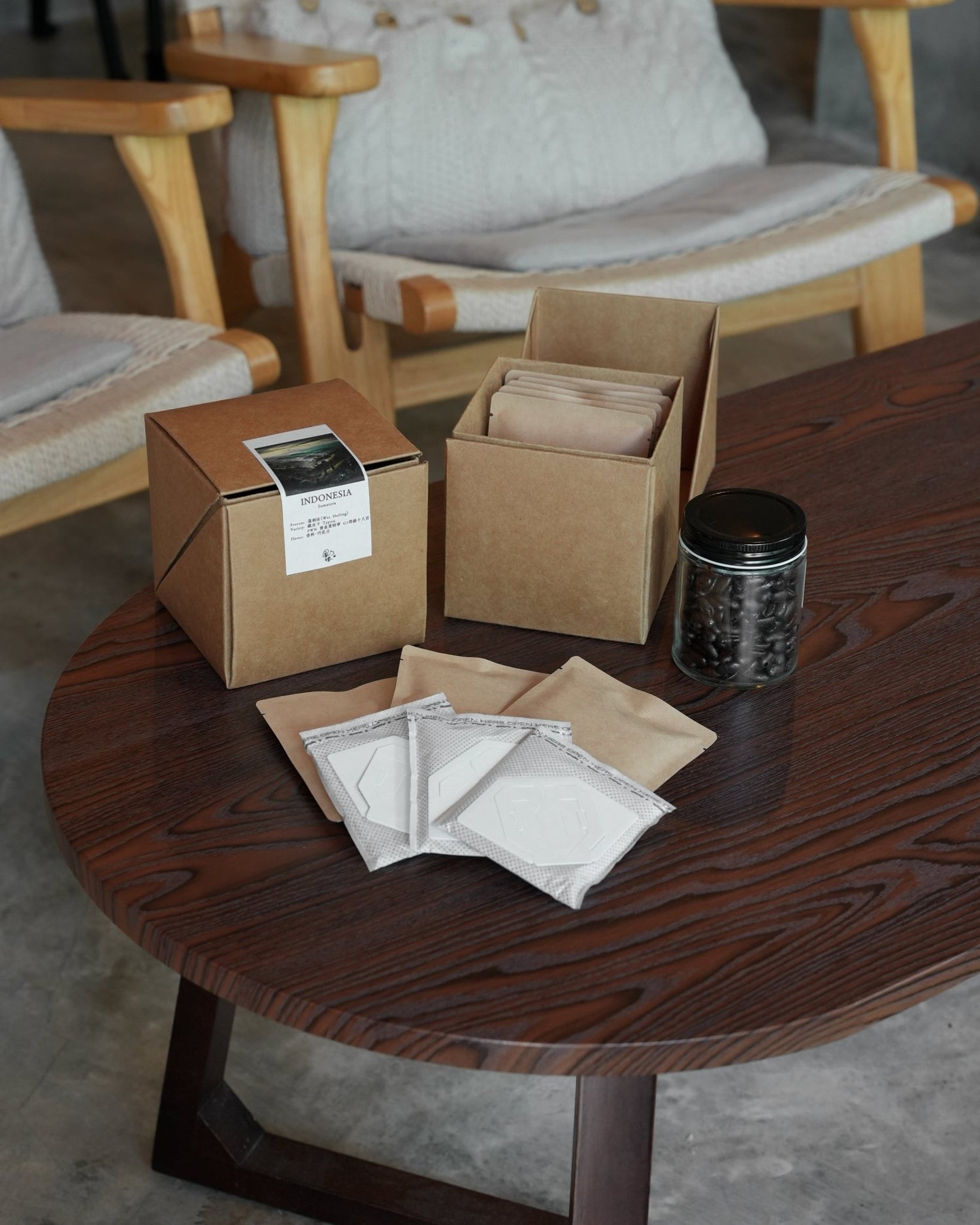 Artisanal coffee packaging display on wooden table featuring boxes, filters, and roasted beans for Sumatera Indonesia Typica coffee by Sip Coffee