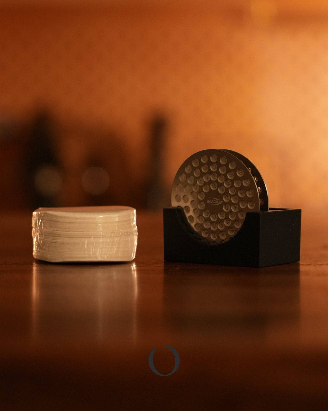 Ikape espresso filter set with dual dispersion screen, 200 filter papers, and holder on wooden surface. Premium coffee extraction tools for optimal flavor and easy cleanup.