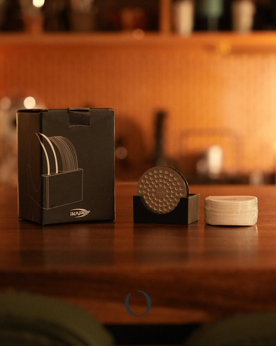 Ikape espresso accessory set with water distribution disk, filter papers, and stand on wooden counter in warm, cozy kitchen setting