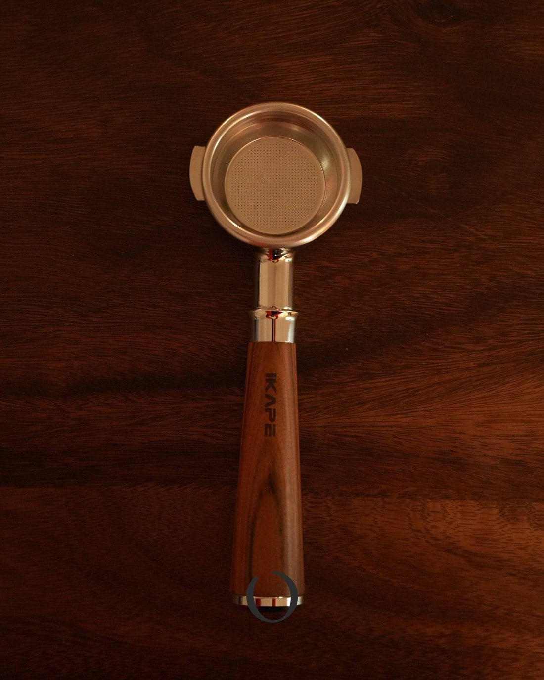 IKAPE 58mm bottomless portafilter with wooden handle and stainless steel filter basket, showcasing professional espresso extraction capabilities on dark wooden background