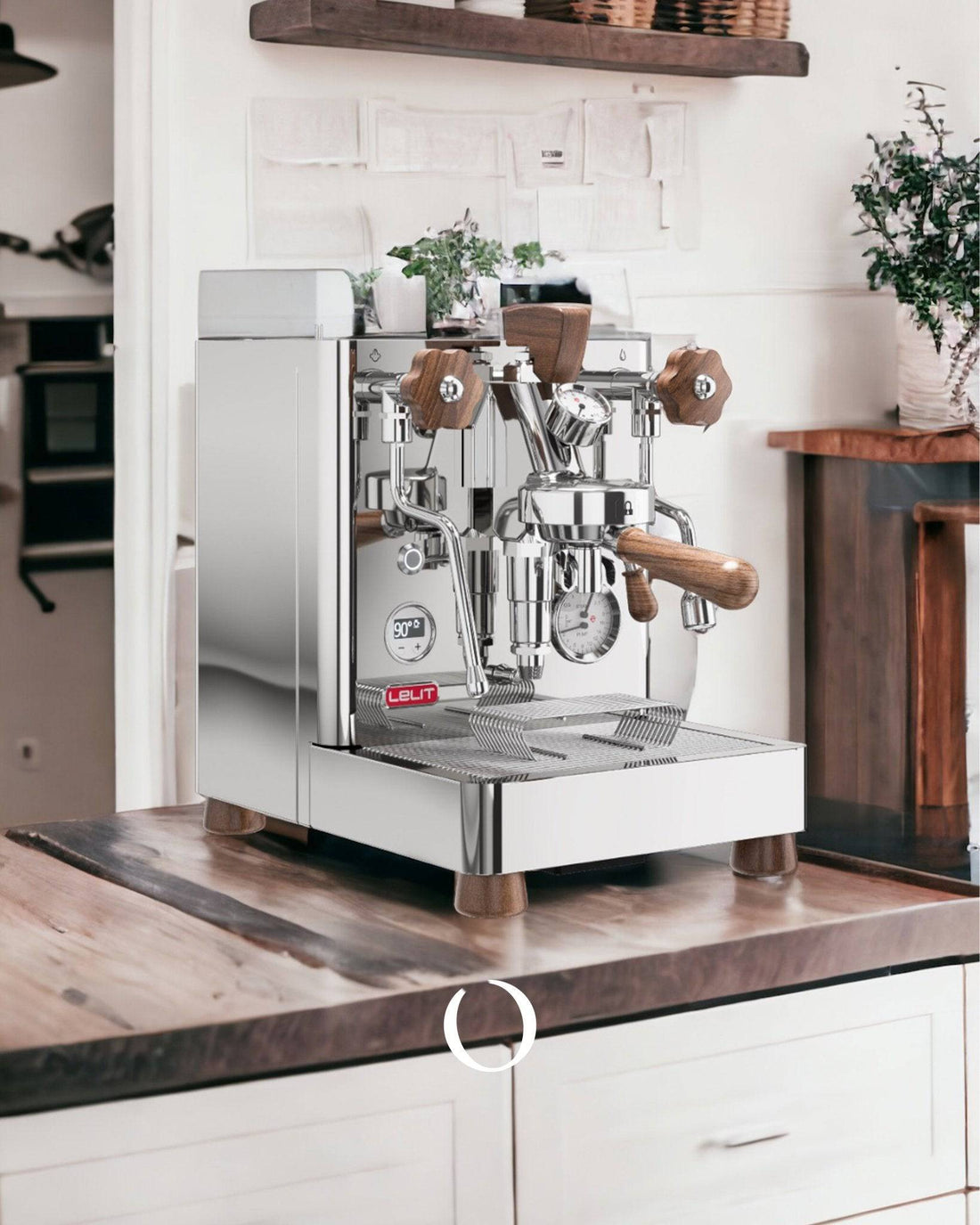 Stainless steel espresso machine with wooden accents on kitchen counter, surrounded by white cabinets and plants, creating a modern and inviting home coffee station.