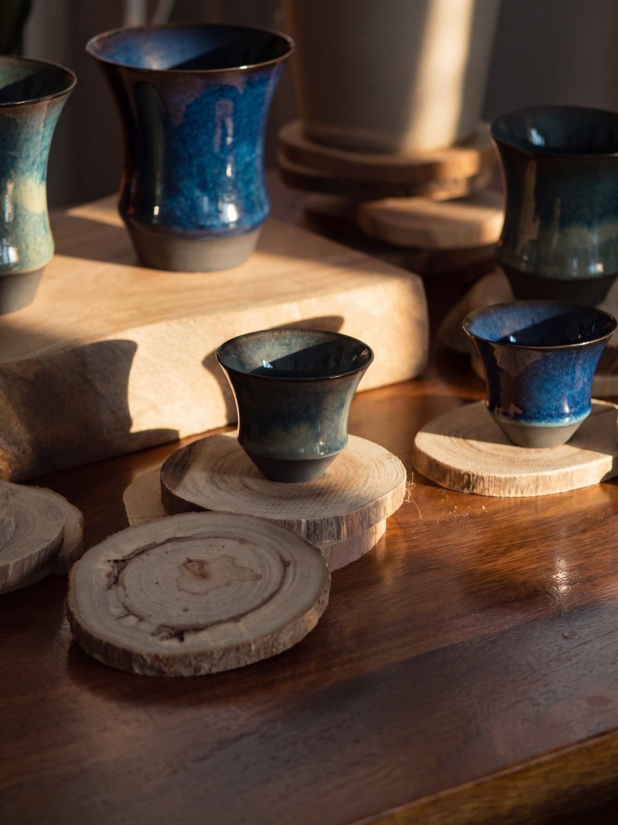 Sharing Cup pieces arranged on a workshop table, with blue-green glaze in different depths